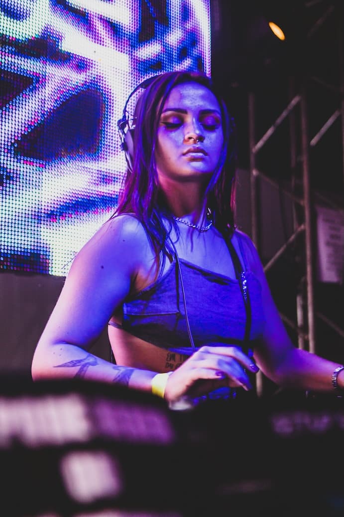 DJ performing under purple stage lights